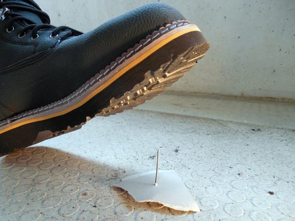 A shoe, a few inches away from stepping on a nail.